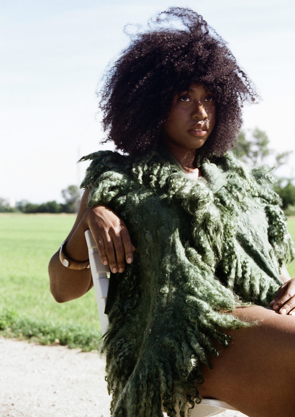 Wet-felted moss-green top worn in a field